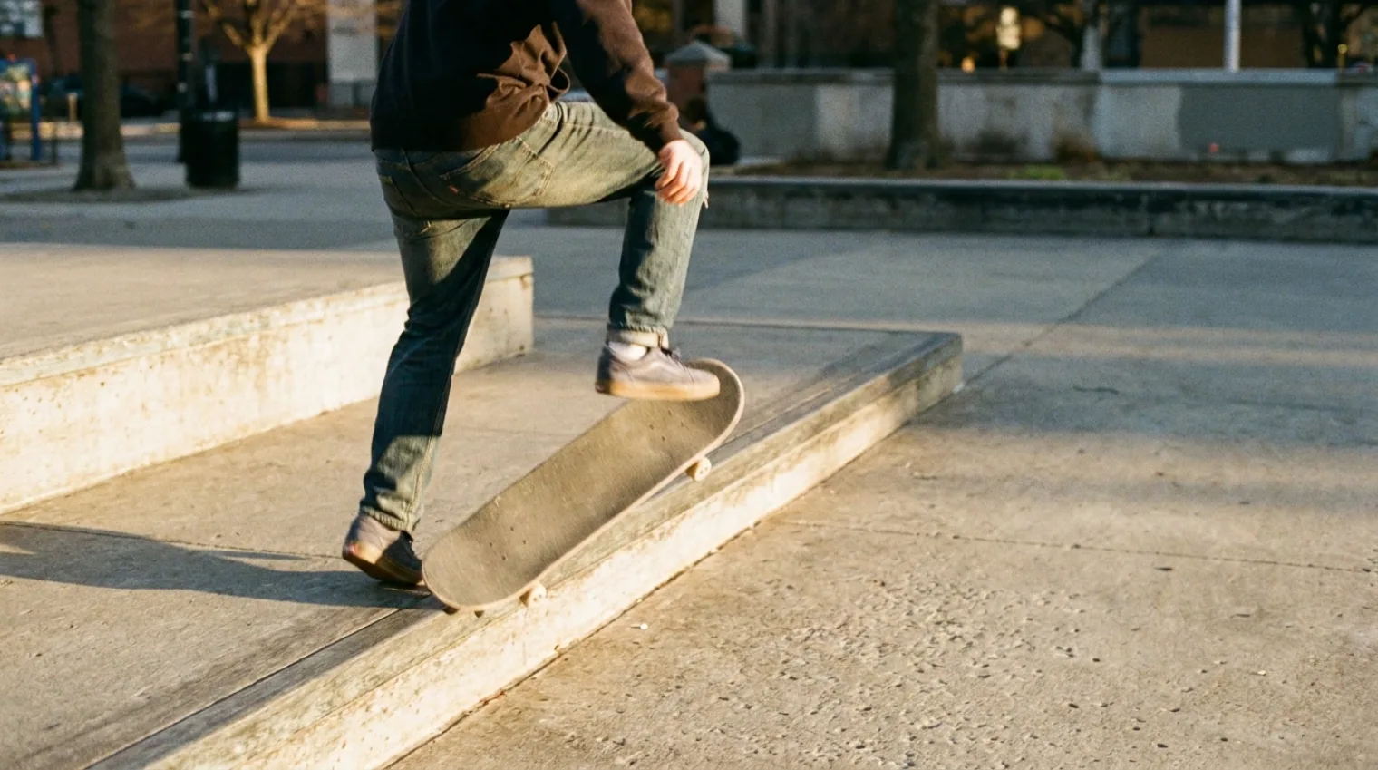 Skateboarder popping off the nose of the board for a nollie, riding forward in normal stance