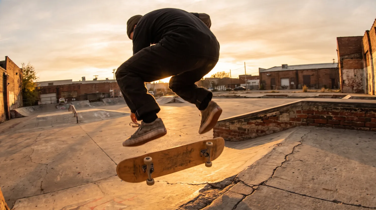 Skater performing a pop shove-it with the board rotating 180 degrees beneath their feet
